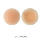 Two champagne-colored silicone nipple covers on a white background 