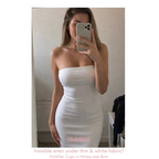 Woman wearing HoldHer Cups under white strapless dress taking a mirror selfie.