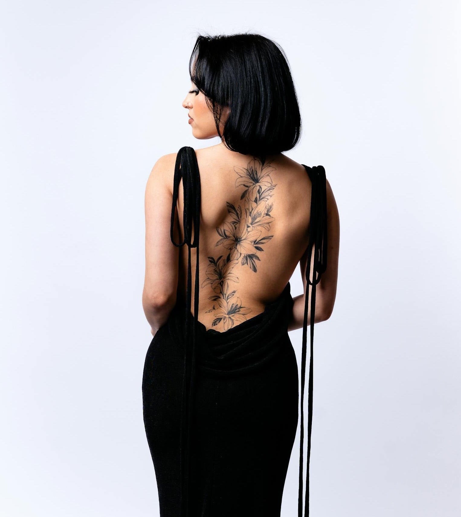 Woman wearing a backless dress with HoldHer best boob tape and bra alternatives designed for fuller busts and D+ cups.